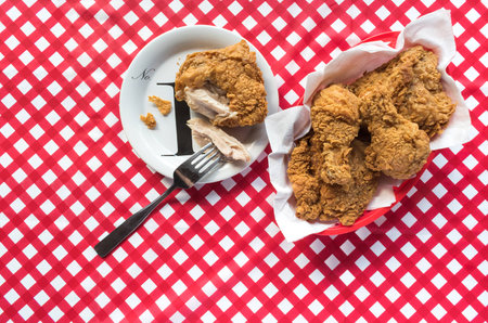 Fried chicken basket with plate on red checkerboard tableclothの写真素材