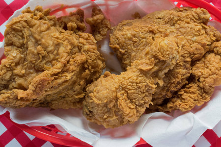 Fried chicken basket on red checkerboard tableclothの写真素材