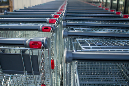 shopping trolleys lined up outside supermarket storeの写真素材