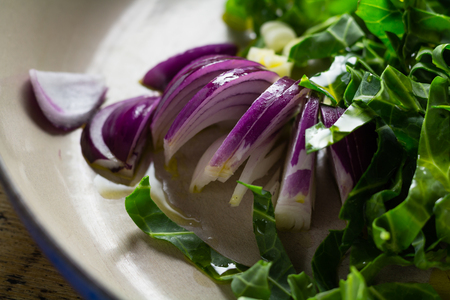 sliced red onion with shredded cabbage in a cooking potの写真素材