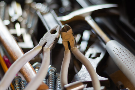 Close up of pliers, a hammer and other tools in a toolboxの写真素材