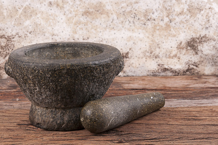 Stone mortar and pestle on old wood boardの写真素材
