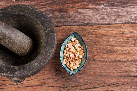 Stone mortar and pestle with nuts old wood boardの写真素材