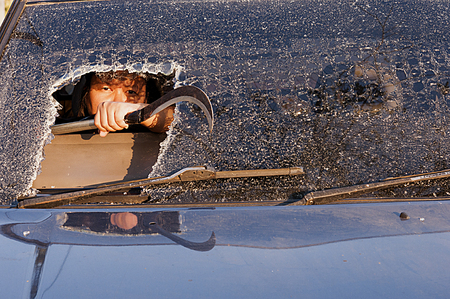 Girl in the car at windshield face crack.の写真素材