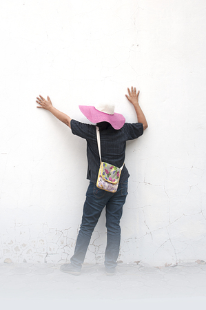 Portrait of happy hipster girl in pink hat and glasses white wallの写真素材