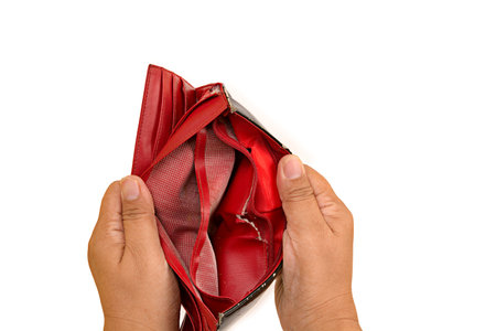 Financial difficulties concept,woman hands holding old red wallet isolated on white background