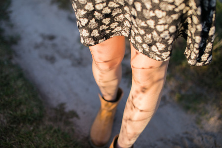 Image of legs of a young woman at sunsetの写真素材