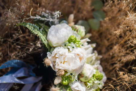 Beautiful withe flowers for loft style wedding decoration. Nice David Austin roses. Romantic bouquet for a brice. Blurred backgroundの写真素材