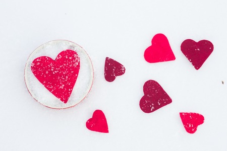 Red felt hearts on snow, Valentine's Day. Snowflakes on heart. Valentines day, love concept. White backgroundの写真素材