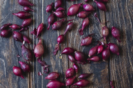 Background of fresh small red onion, organic local produce. Vegetarian vegan healthy food. Grow your own, eat localの写真素材