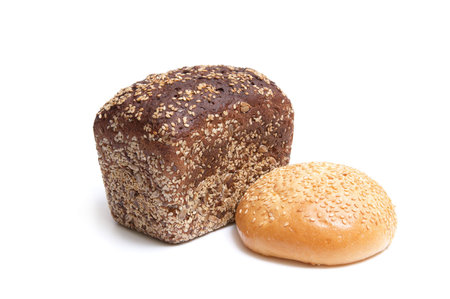 Loaf of bread and bun full of seeds isolated on a white background.