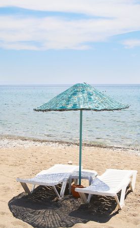 Parasol and lounge-chairs on the beach resort.の写真素材