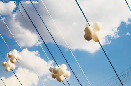 White balloons flying high in the sky.の写真素材