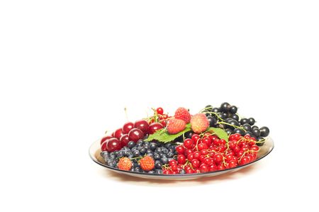 Mix of whortleberries, currant,raspberries and cherries isolated on a white background.の写真素材