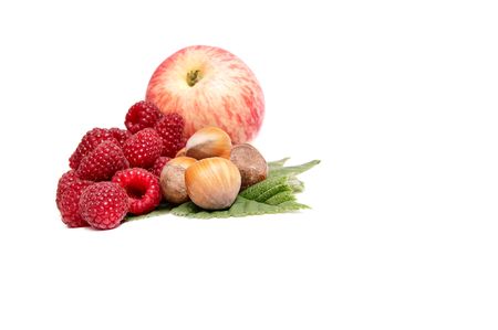 Ripe apple,hazelnuts and raspberries isolated on a white background.の写真素材