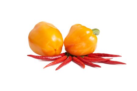Two yellow and several red peppers isolated on a white background.の写真素材