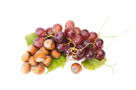 Hazelnuts and ripe pink grapes isolated on a white background.の写真素材