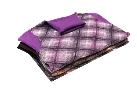 Stack of modern sweaters isolated on a white background.の写真素材