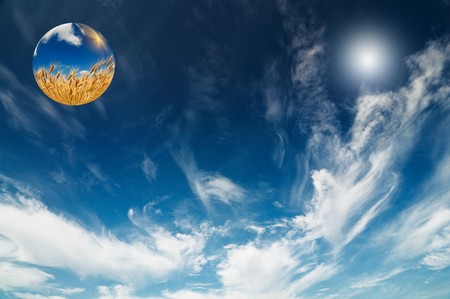 Blue-blue sky with clouds and ball with wheat.の写真素材