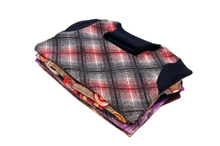 Small stack of modern sweaters isolated on a white background.の写真素材