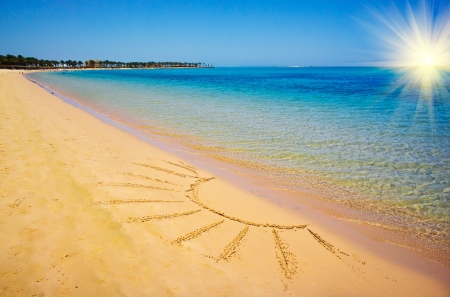 Sun drawn on the sandy beach の写真素材