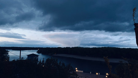 dark clouds and raining from afar at night. mobile photographyの写真素材