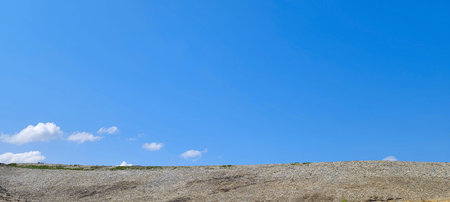 Backhoe working on garbage dump in landfill. People Working at Landfill site.の写真素材