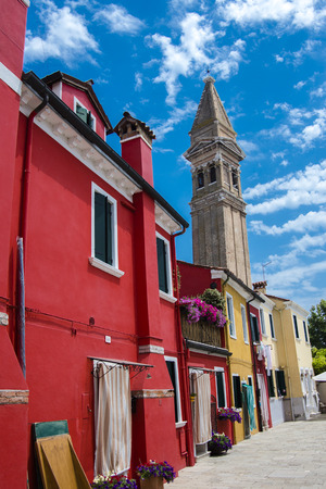 Colorful buildings an a leaning tower of an old church on Burano island, Venice, Italyの写真素材