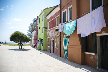 Venice, Burano island street detail with hanging wash laundry.の写真素材