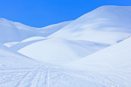 winter landscape with snowy hills  under a blue sky above the Arctic Circle in Russiaの写真素材