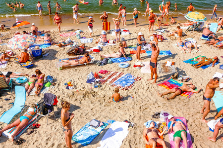 a lot of people sunbathing on the beach in the south in the summerのeditorial素材