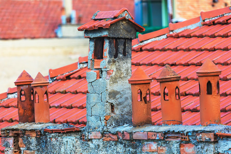 Architecture details of the house with old chimney and tile roof on the backgroundの写真素材