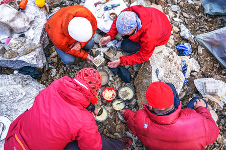 CAUCASUS, KABARDINO-BALKARIA, RUSSIA - JULY 24, 2014: Group of tourists having dinner on a campのeditorial素材