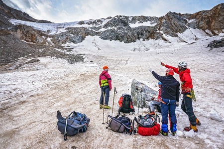 CAUCASUS, KABARDINO-BALKARIA, RUSSIA - JULY 23, 2014:  Group of climbers discusses the route of the mountain passのeditorial素材