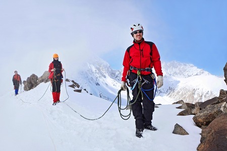 Dugoba, Pamiro-Alay, Kyrgyzstan - May 02, 2013: Group of mountaineers ascent to the mountain on a complex slope is composed of rock and snowのeditorial素材