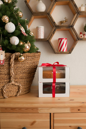 Boxes of pastries are at the Christmas treeの写真素材