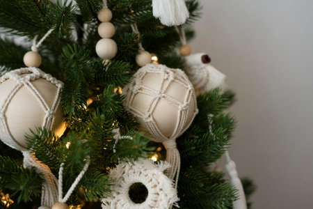 Handmade toys hang on an artificial Christmas treeの写真素材