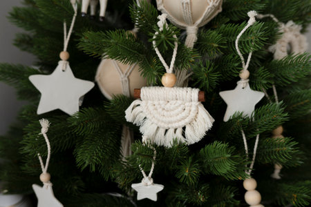 Handmade toys hang on an artificial Christmas treeの写真素材