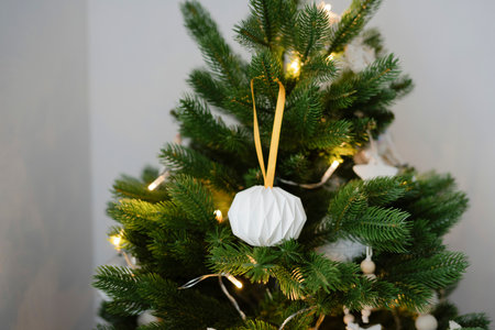 Handmade toys hang on an artificial Christmas treeの写真素材