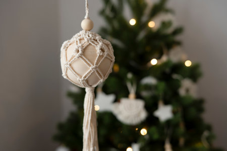 A woman's hand holds a handmade toy for the Christmas treeの写真素材