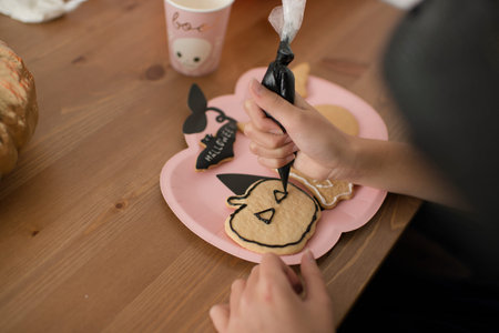 Children are coloring gingerbread cookies for Halloween.の写真素材