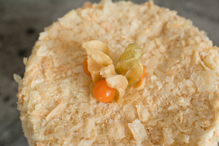 Layered cake on a plate decorated with physalisの写真素材