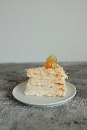 Layered cake on a plate decorated with physalisの写真素材