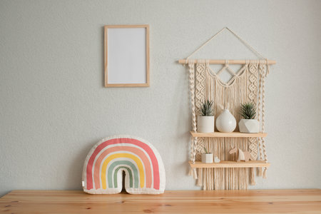 Mockup wooden frame in the interior of the room, macrame shelf and wooden chest of drawersの写真素材