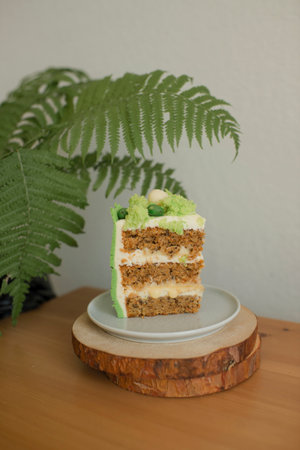 a piece of cake on a wooden stand, baking for a children's holidayの写真素材