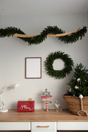 Mockup of a wooden frame in the interior of a room decorated for Christmasの写真素材