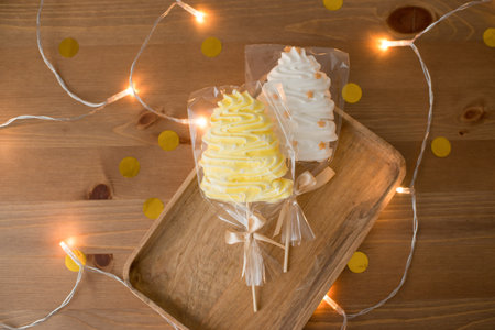 Sweet meringue on a stick in the form of a Christmas treeの写真素材