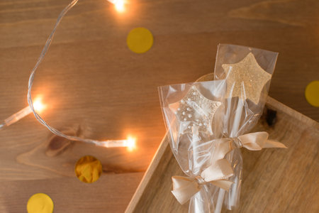 Caramel lollipops in the shape of a star on a wooden tableの写真素材
