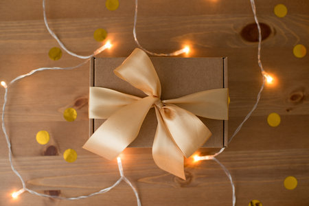 Craft box decorated with ribbon on a wooden table, natural packaging, gift.の写真素材