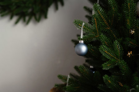 Christmas tree in wicker basket on wooden table and gray wall backgroundの写真素材
